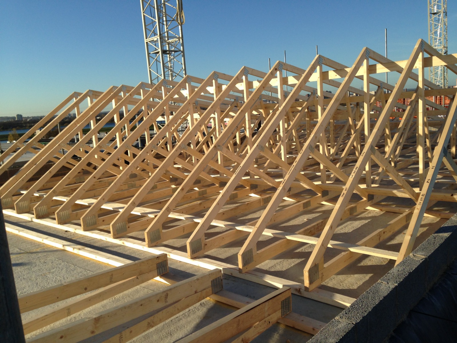 Timber roof trusses under construction