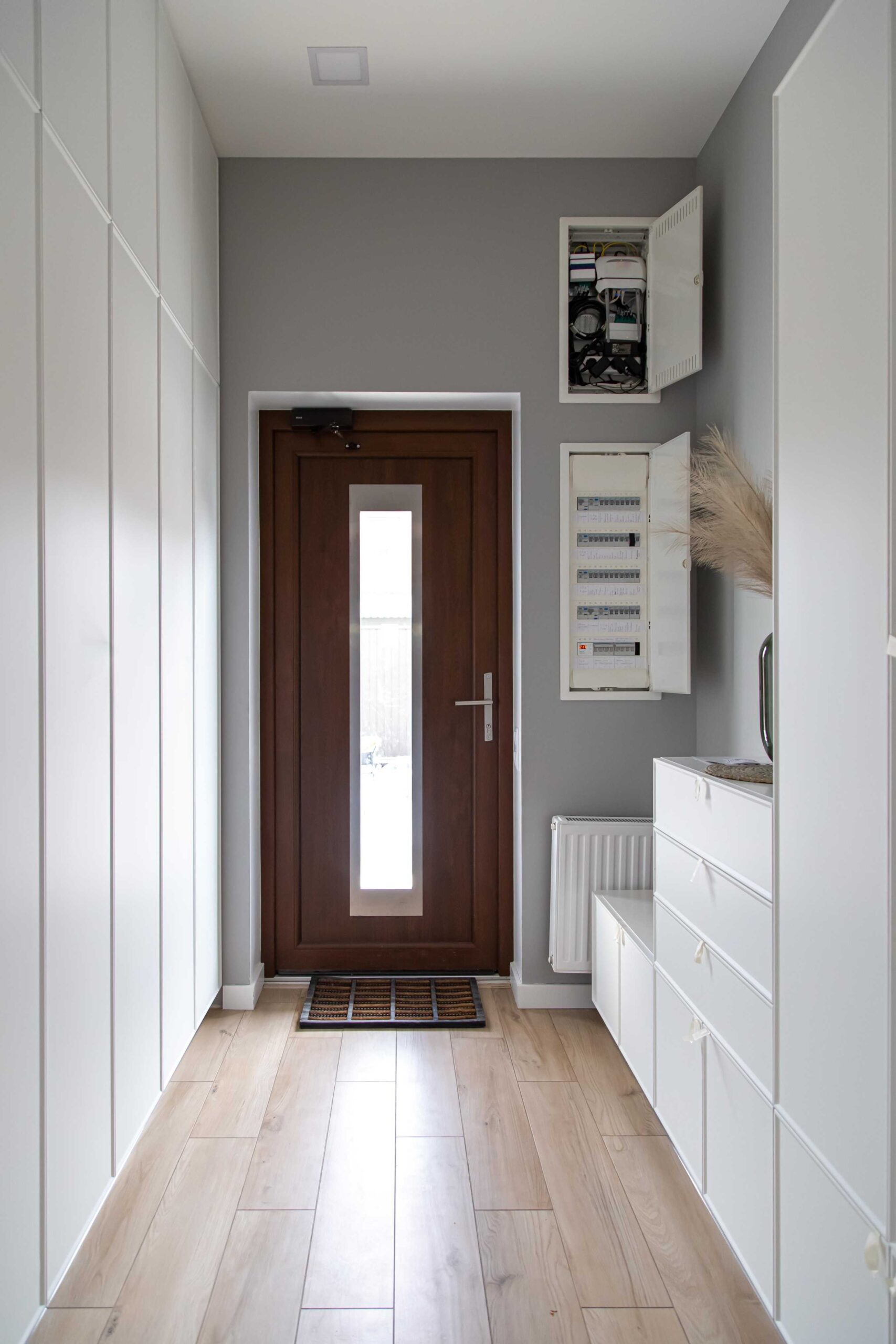 Hallway with a timber front door and fitted storage